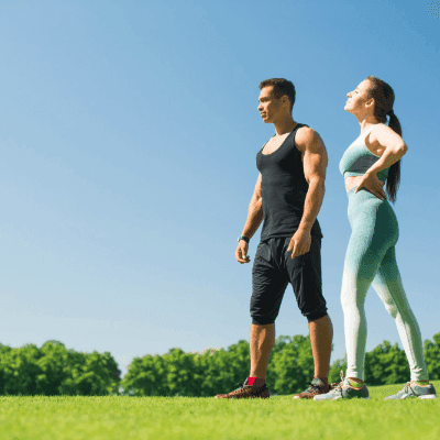 Thumbnail for Tirzepatide treatment where fit couple standing on grassy field, enjoying nature together.